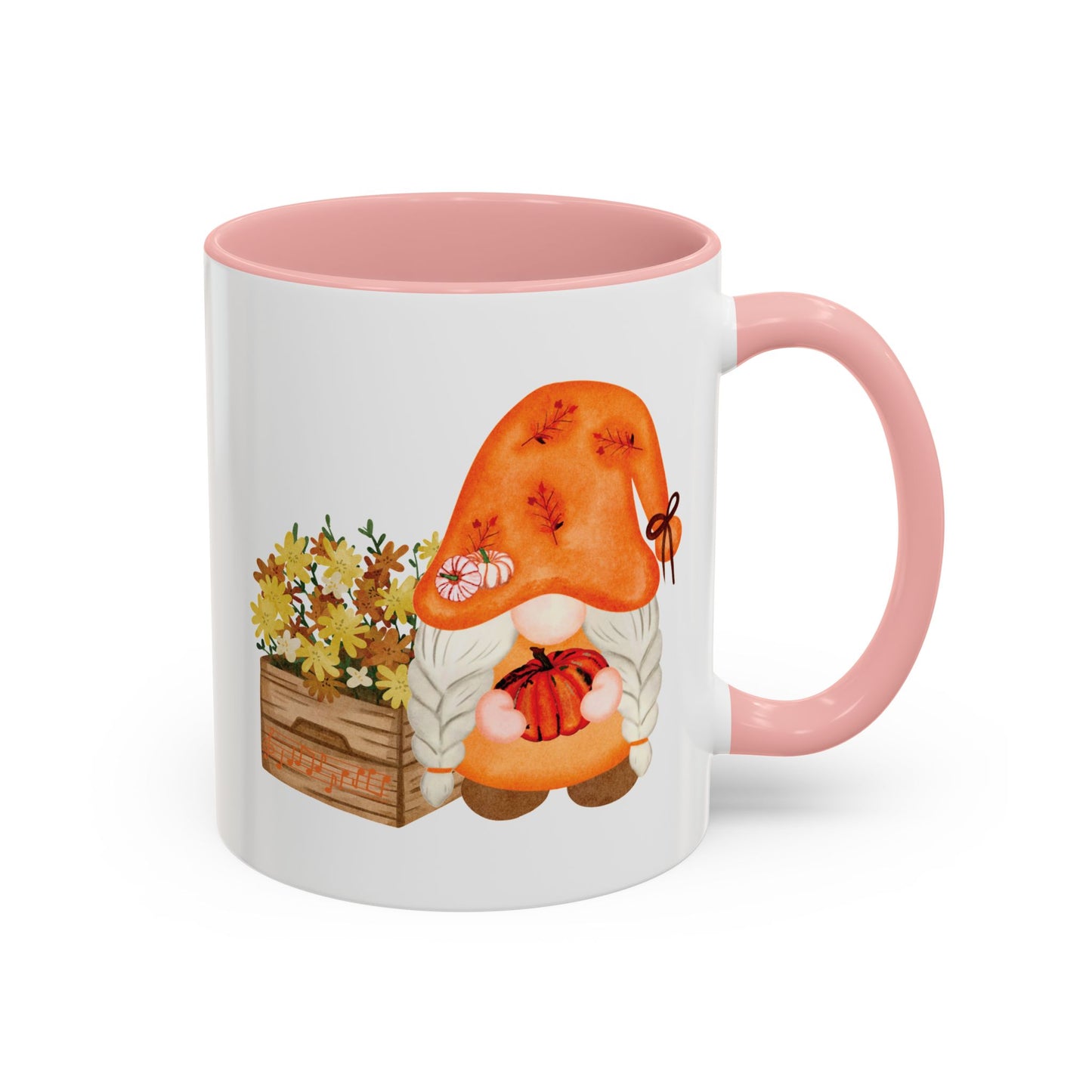 White and pink 
ceramic coffee mug with a colorful graphic of a mysterious gnome surrounded by autumn leaves and mushrooms.