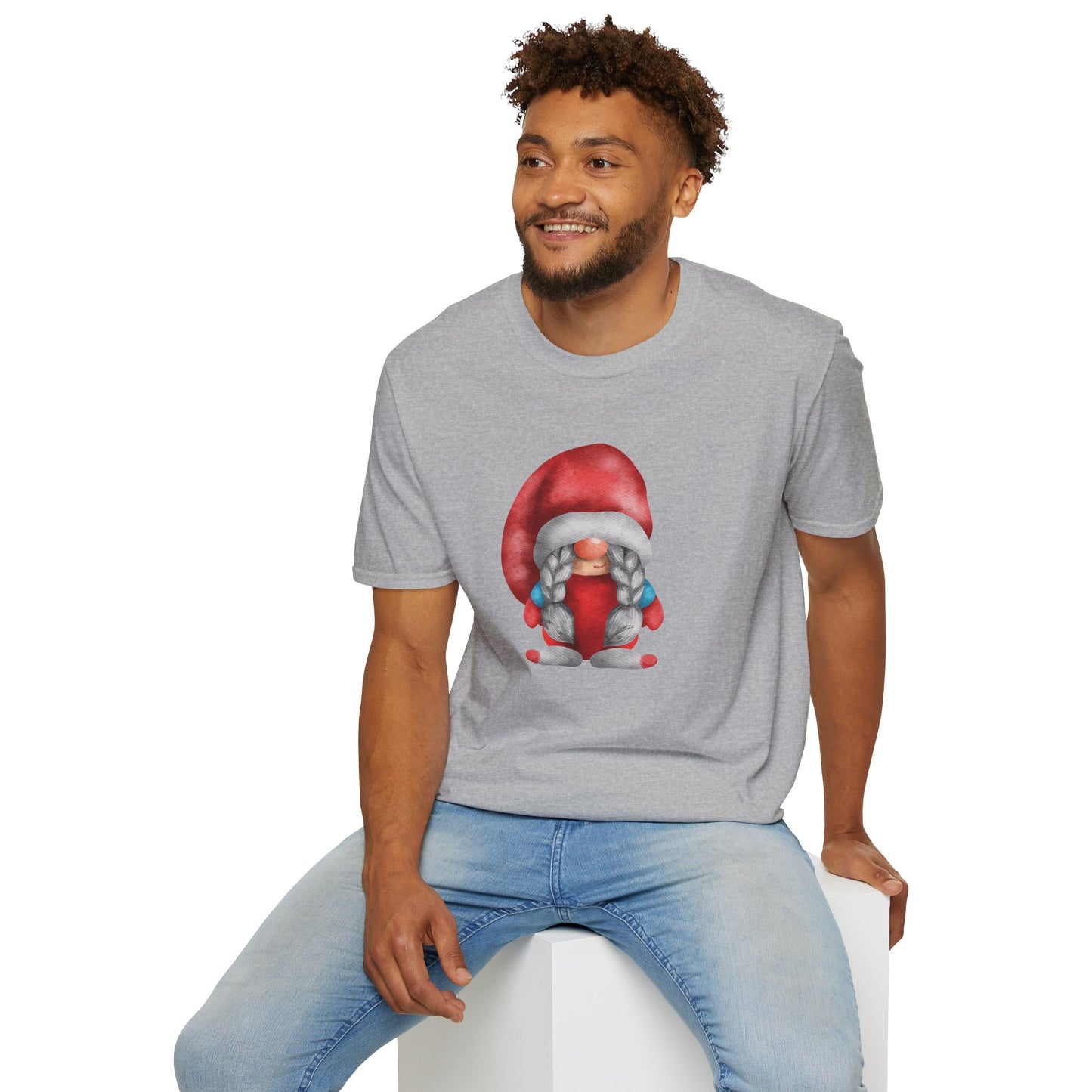 A man wearing a heather gray t-shirt with a colorful graphic of a gnome in a red Santa hat on long braids.