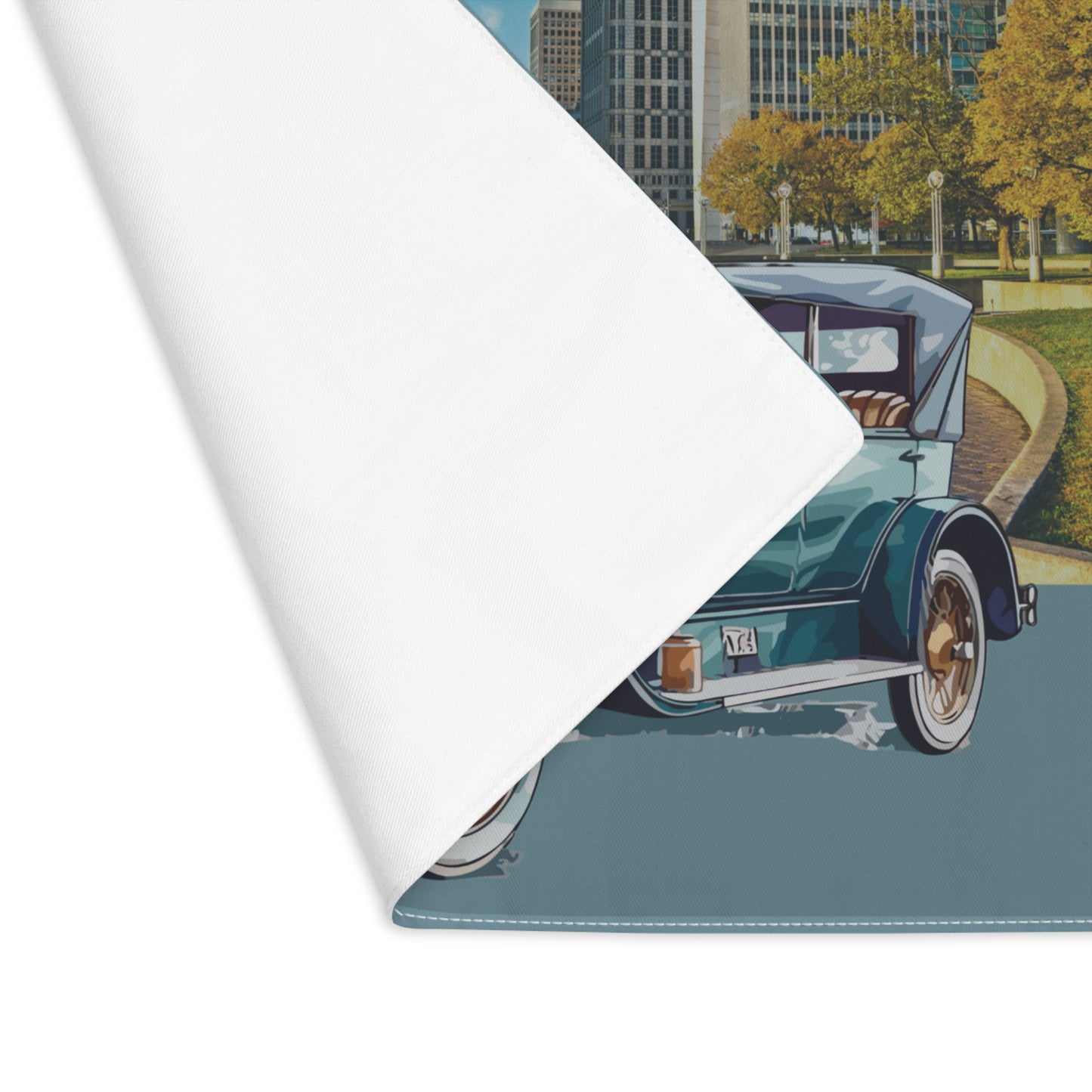 Roll of placemat with a vintage car design on a city street