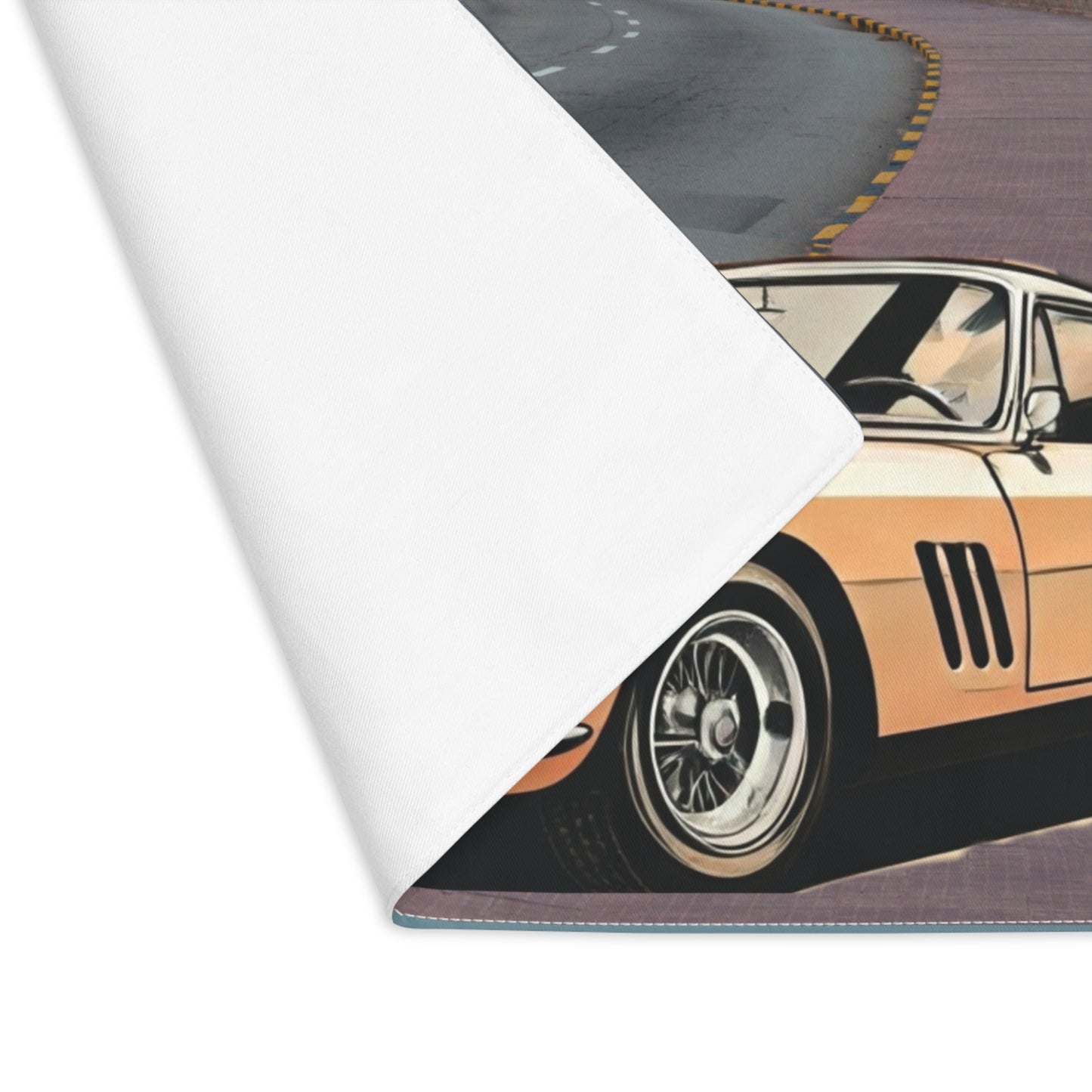 Close-up of a car design on a roll of placemat with a road and car illustration.