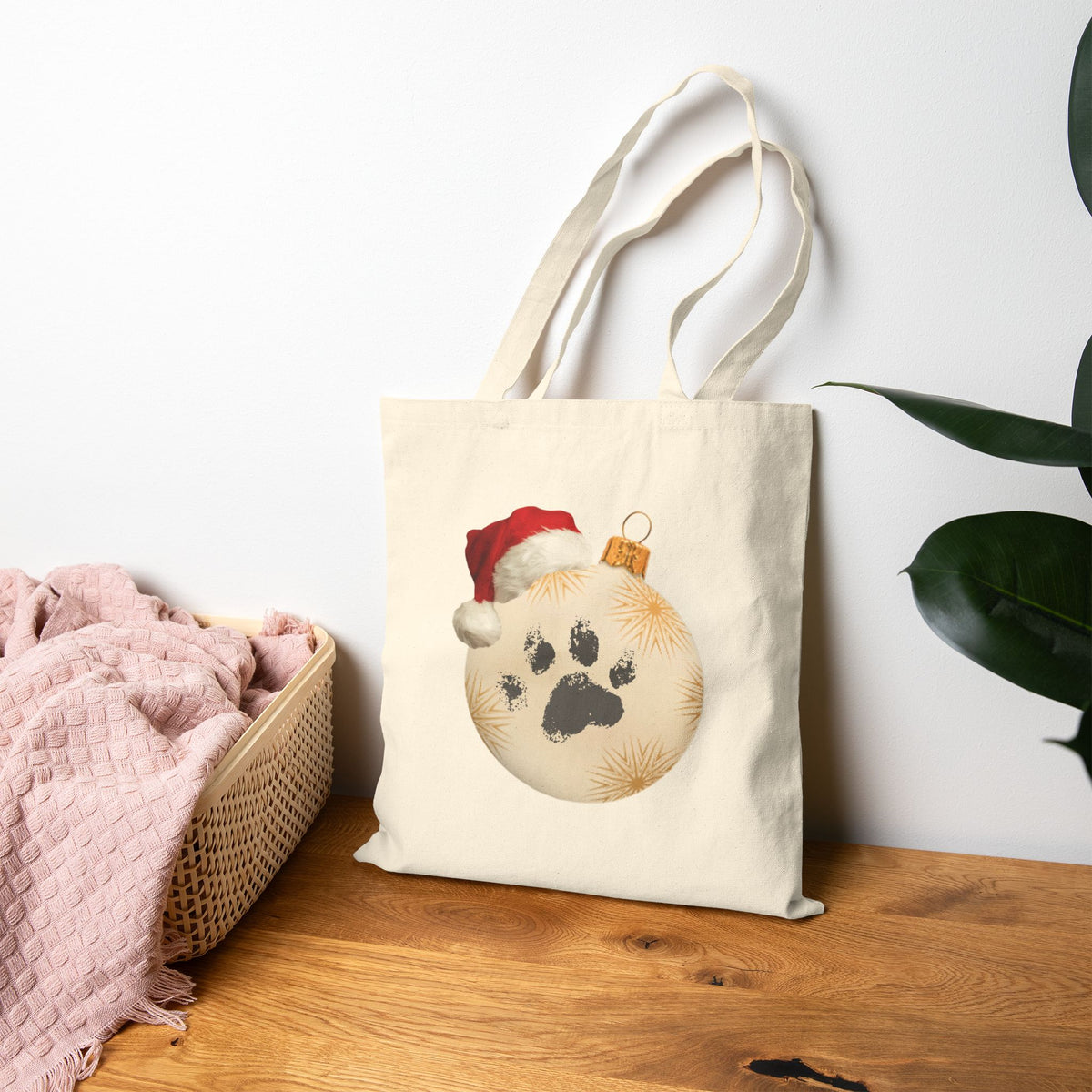 Santa paws paw print ornament canvas tote bag featuring a holiday dog cat paw christmas bauble on natural cotton canvas