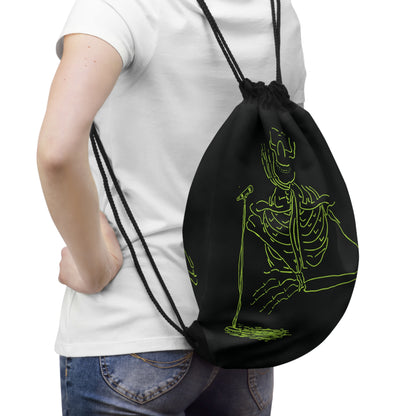 Person wearing a black drawstring bag with a green skeleton design 