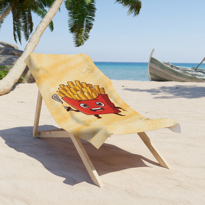 Beach towel with cartoon design of a red character with fries on a sand chair at a beach.