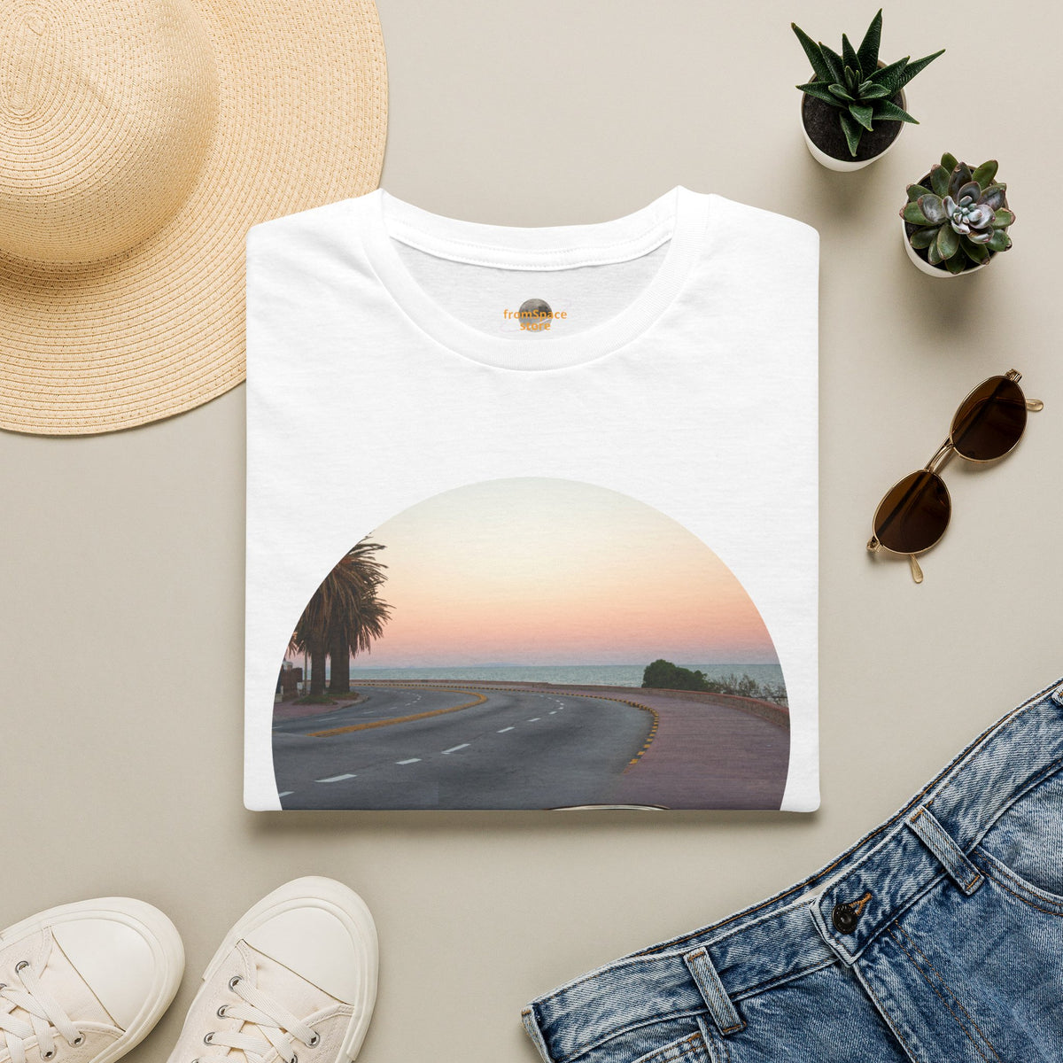 White vintage cars graphic t-shirt laid flat with sunglasses, shoes, and summer flat lay accessories.