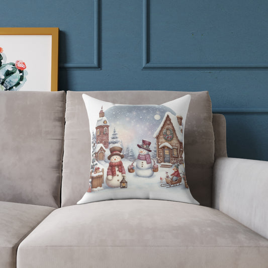 Cozy Christmas throw pillow featuring a vintage snowy village with cute snowmen and rustic cottages displayed on a sofa for nostalgic holiday home decor.