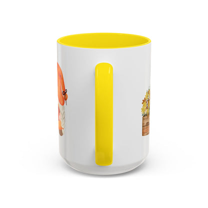 White and yellow ceramic coffee cup with a colorful graphic of a mysterious gnome surrounded by autumn leaves and mushrooms, back detail 