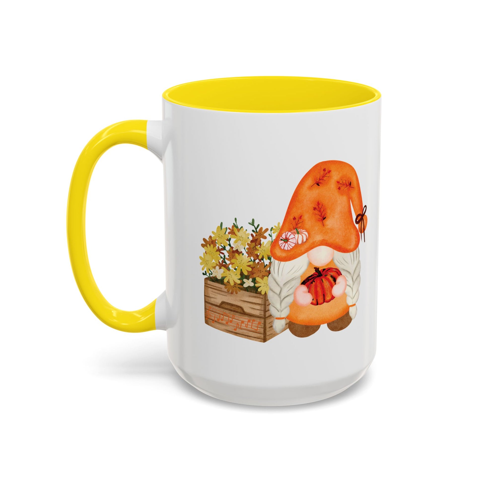 White and yellow ceramic coffee cup with a colorful graphic of a mysterious gnome surrounded by autumn leaves and mushrooms.