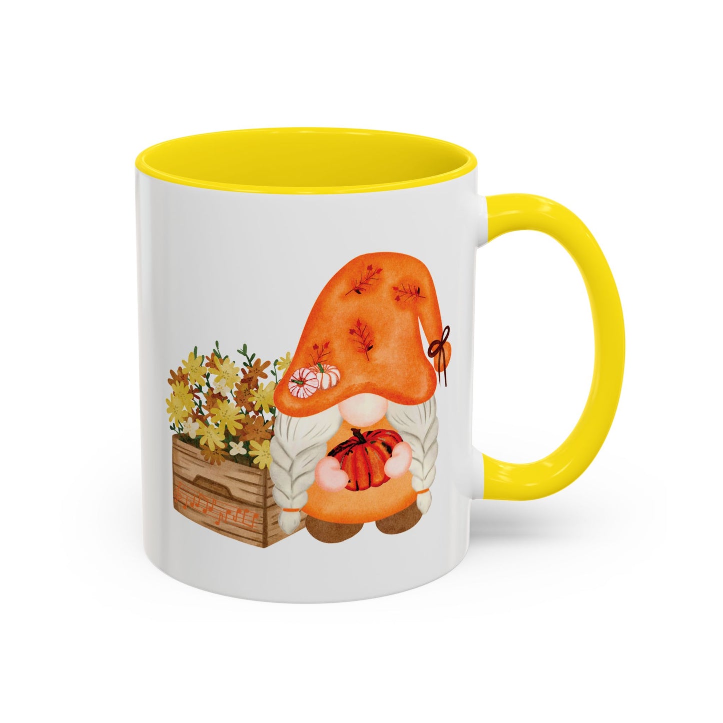 White and yellow ceramic coffee mug with a colorful graphic of a mysterious gnome surrounded by autumn leaves and mushrooms.